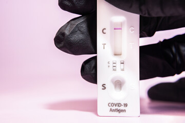A negative test for testing for the COVID-19 viral disease 2019-Nov. Laboratory card for testing for the new viral coronavirus sars-cov-2 on a pink background