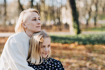 Mother-Daughter Relationship. How to Find Common Ground with Teenage Daughters. Happy teen girl walking and playing with her mom in autumn park.