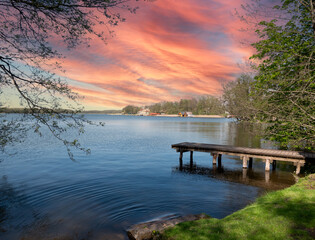 Sunset on a lake in the Mecklenburg Lake District with a wooden jetty