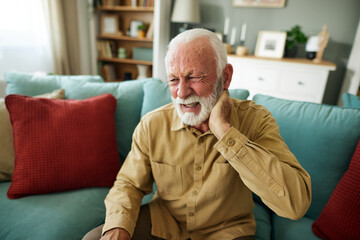 Senior man feeling exhausted and suffering from neck pain