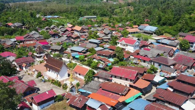 Aerial Flying Over Tin Rooftops Of Whiskey Village In Luang Prabang, Laos . Pull Back Shot
