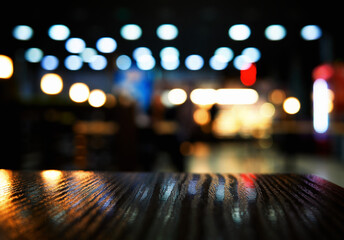 Bottom aligned wooden table in bokeh night city illumination © spacedrone808