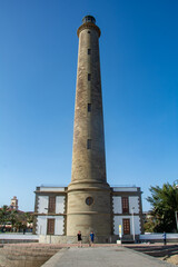 Lighthouse in Maspalomas, Gran Canaria, Spain with palm tree - obrazy, fototapety, plakaty