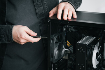 A computer technician installs a computer power supply. Assembling PC