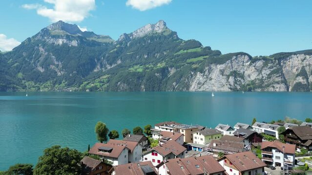 Swiss town on the shore of a mountain lake, view from a drone.
