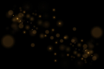 Light abstract glowing bokeh lights. Bokeh light effect on a black background. Festive golden glowing background.