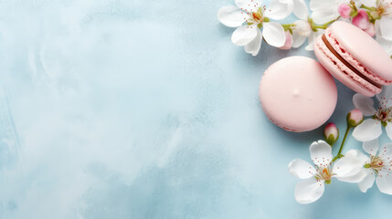 Flat lay pink macaron and white flower on a light blue background with a marble pattern