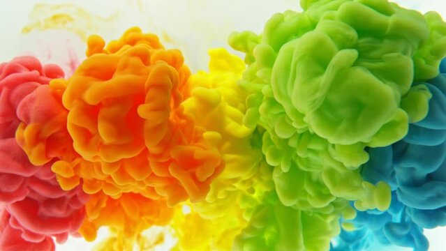 Super Slow Motion of Colored Paints Mixing in Water. Isolated on White Background. Filmed on High Speed Cinema Camera, 1000fps. Speed Ramp Effect.
