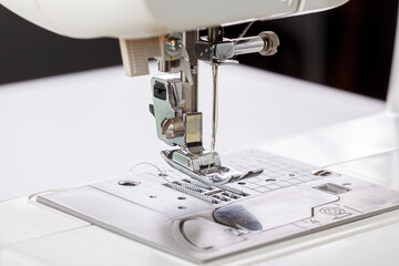 Sewing machine, stitching fabrics, needle in a round plan