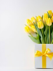 Bouquet of yellow tulips in a gift box on white background.