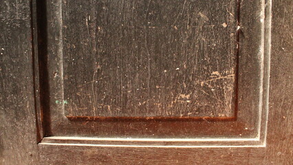 Detailed Image Showing Rough, Scratched Black Wood Door Surface
