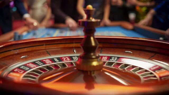 Close Up of a Spinning Roulette Wheel with the Ball Rolls Into a Black Pocket with Number Four. Casino Players Making Bets at a Roulette Table. Young People Enjoying Nightlife in a City