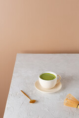 Vegan green matcha drink in a cup with chasen. Healthy drink, lactose, gluten and sugar free.