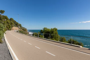 Foto op Canvas A long bike path overlooking the sea with no one around. © alexandre zveiger