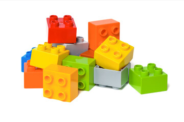 Pile of colorful toy bricks on white. Educational toy for children.