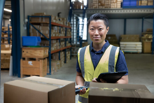Portrait of employee loading van in distribution warehouse
