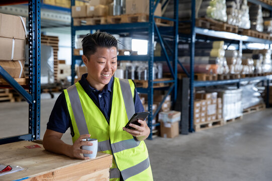 Portrait of employee in distribution warehouse on a coffee break