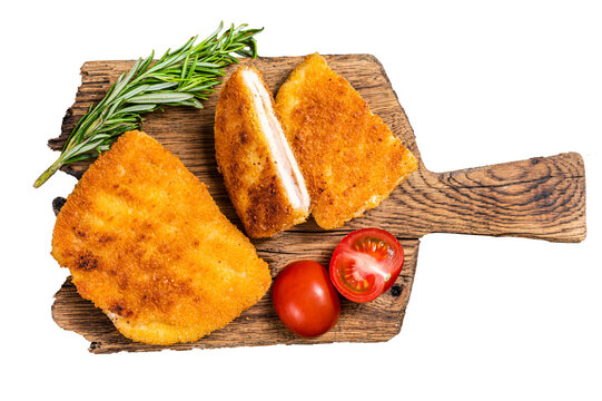 Crispy Cordon Blue Chicken fillet roll with ham and cheese served  on a wooden board.  Transparent background. Isolated.