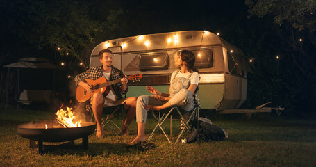Couple in a Relationship Enjoying a Summer Evening at a Caravan Camping Area. Handsome Boyfriend...