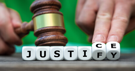 Hand turns dice and changes the word justify to justice. - obrazy, fototapety, plakaty