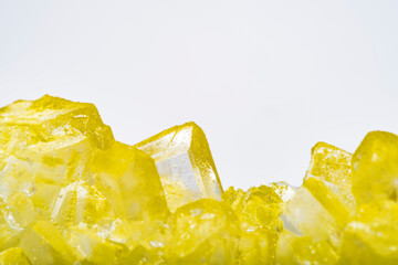 Background with colorful wet fruit ice crystal and blank space. Close-up of a yellow food crystal...