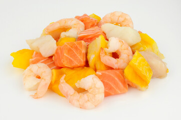 Group of fresh raw prawns, salmon, cod and smoked haddock chunks prepared for a fish pie
