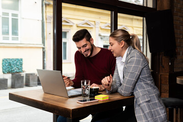 Owner and manager of cafe restaurant making financial report calculating profit and expenses ordering drinks and food. Small private cafeteria workers working on taxes and wages for employees.