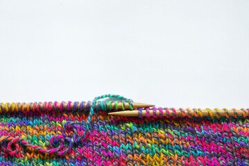 Knitting colorful yarn, wooden needles. Handmade hobby concept
