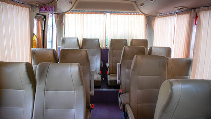 comfortable passenger bus interior with upholstered seats; individual transfer for a group of people