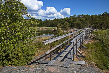 Wooden footbridge on hiking track on Stora Krokholmen in Stendörrens Naturreservat in Sweden, Europe
