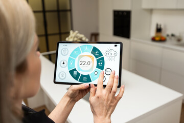 Smart home control on tablet. Interior of living room in the background