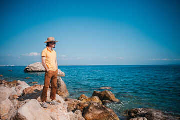 Stylish gent by the sea, savoring the journey with seaside elegance and poise