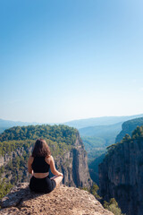 Naklejka na ściany i meble Woman exploring Turkey's canyon, embracing the wonder of nature's majestic ravines