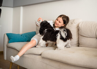 Girl with a dog. 9-Year-Old Girl Playing with Her Small Dog at Home