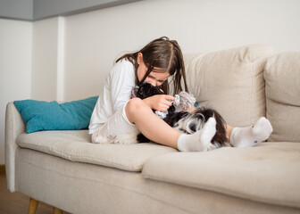 Girl with a dog. 9-Year-Old Girl Playing with Her Small Dog at Home