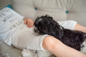 Girl with a dog. 9-Year-Old Girl Playing with Her Small Dog at Home