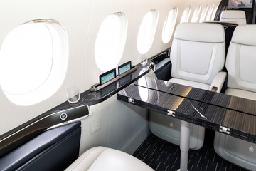 Comfortible chairs in a modern business jet aircraft - 681489571