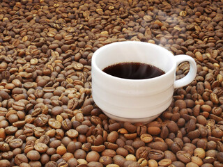 Coffee cup on coffee beans texture background.