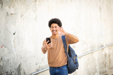happy young man making video call with mobile phone