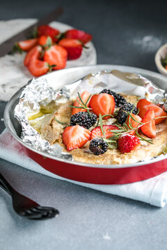 French cuisine. Baked camembert cheese with strawberry on a light background, banner, menu, recipe place for text.