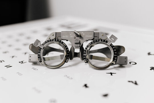 Image of test glasses with letter diagram for eye examination, vision optometry background. Vision diagnostics and prevention concept.