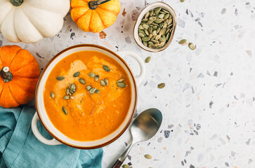 Roasted pumpkin and carrot soup with cream and pumpkin seeds