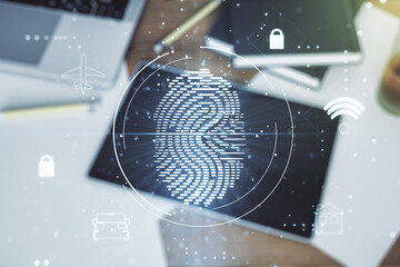 Multi exposure of creative fingerprint hologram and digital tablet on background, top view, personal biometric data concept
