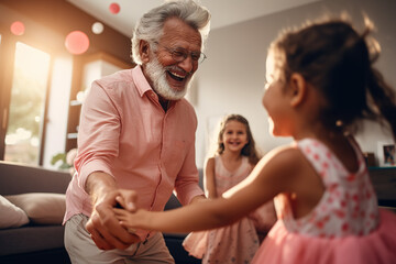 Elegant loving caring grandfather dancing with his cute little granddaughter. Adorable granddaughter and positive grandpa holding hands while dancing together in living room at home. Family concept.
