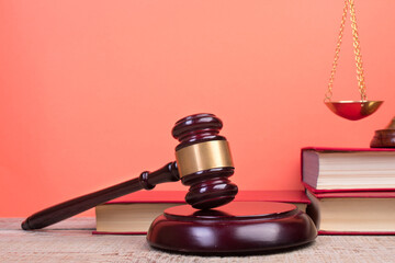 Law concept - Open law book, Judge's gavel, scales, Themis statue on table in a courtroom or law...