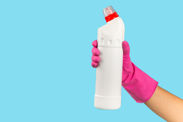 A cleaner's hand in a rubber protective glove holds a bottle of cleaning chemical on a blue background. Commercial cleaning company. Spring regular cleaning. Space for text or logo.