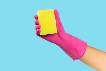 Cleaning with rubber gloves and sponge on texture background. Cleaning sponge in hands with place for text. Cleaning concept. Sponge for washing dishes.