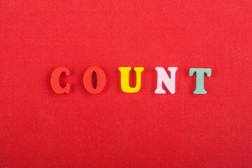 Fototapeta na wymiar COUNT word on red background composed from colorful abc alphabet block wooden letters, copy space for ad text. Learning english concept.
