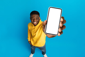 Cool african american guy showing phone, high angle view