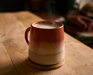 Close Up Of Steaming Mug Of Hot Coffee On Table